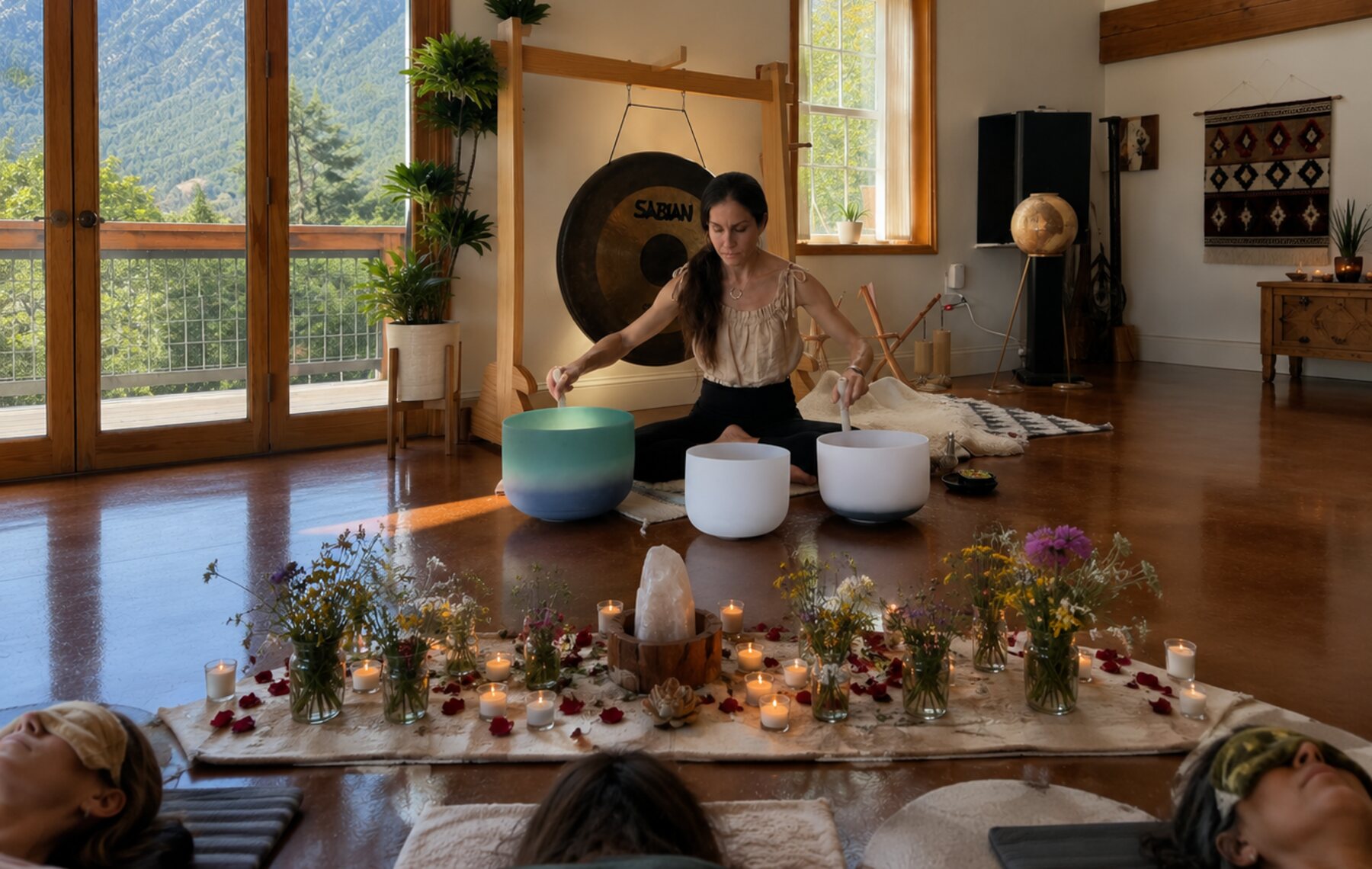 Crystal alchemy sound ceremony with singing bowls, candles, flowers, and an elemental altar